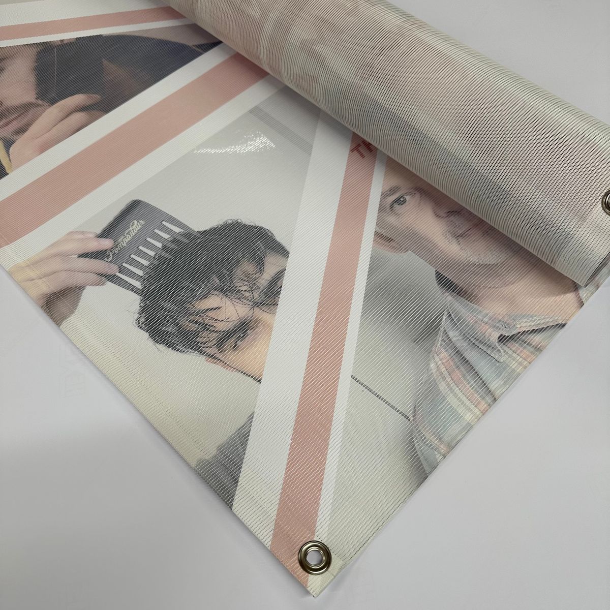 A large-format printed mesh banner with a fine perforated surface for wind resistance