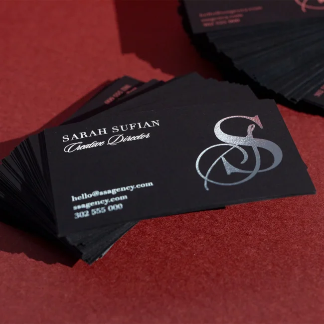 Black business cards with silver foil · true-black uncoated coloured stock · full-colour digital print · silver flat foil