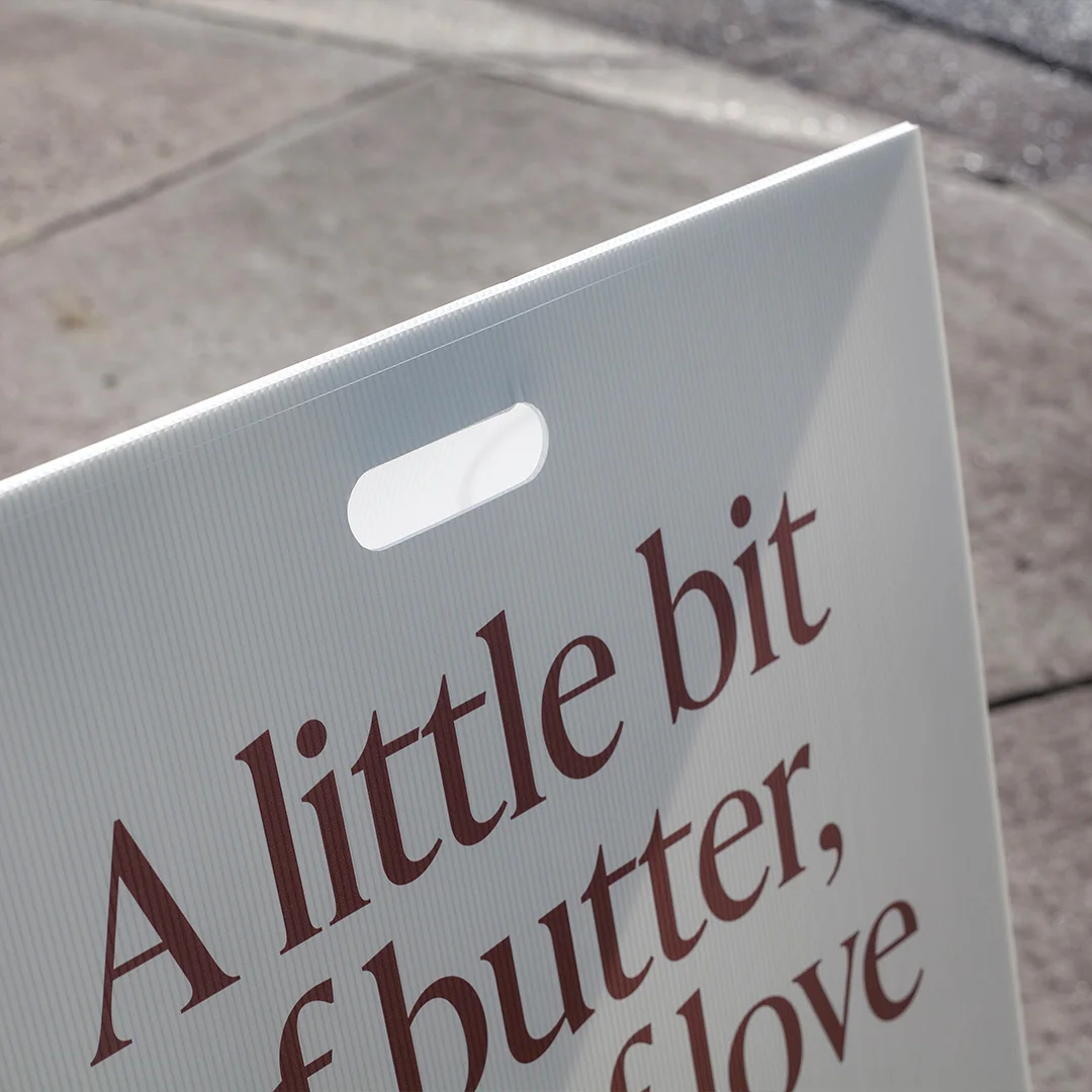 Corflute A-frame sign on pavement outside cafe