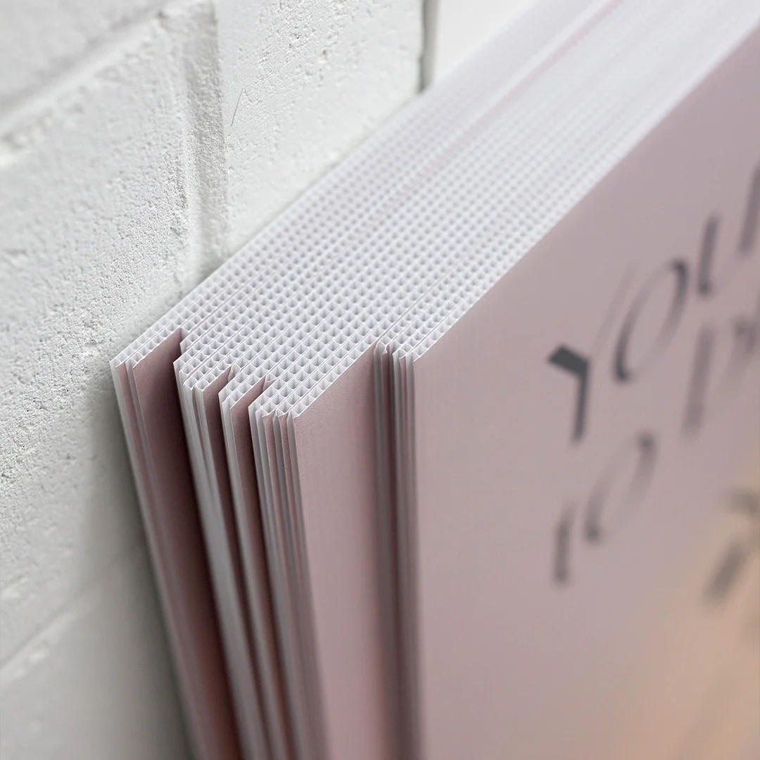 Stack of corflute sign boards showing fluted plastic construction