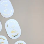 Gold foil oval stickers with hand-crafted design