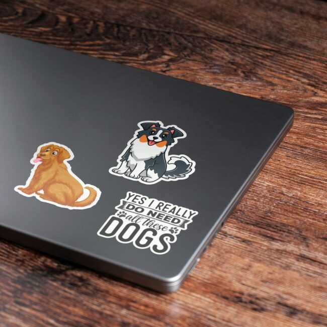 Custom die-cut vinyl stickers (~70mm) applied to a closed laptop lid - sizing example for the 50-100mm range