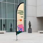 Bow banner advertising a children's carnival fair, curved blade flag standing outside a public building