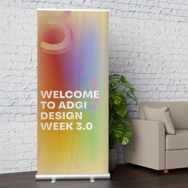 Pull-up banner displaying a welcome message, retractable banner stand set up indoors at an event