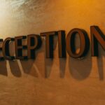 Custom acrylic reception panel sign mounted on a corporate office feature wall with standoff fixings