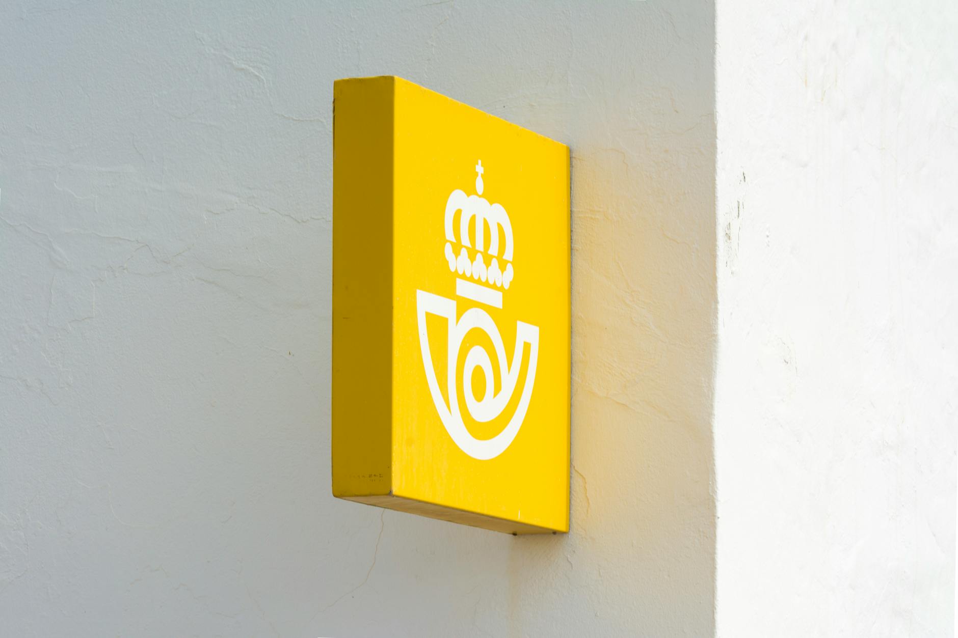 Close-up of silver standoff fixings on an acrylic corporate panel sign showing the floating gap effect