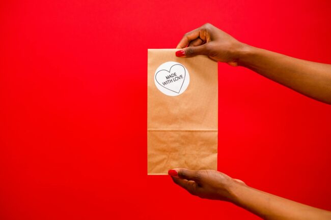 A branded product with custom die-cut label stickers applied to packaging, showing professional finish at scale with consistent colour and c