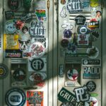 Assortment of custom sticker sheets spread on a retail surface showing multiple themed designs on A4 and A5 sheet formats