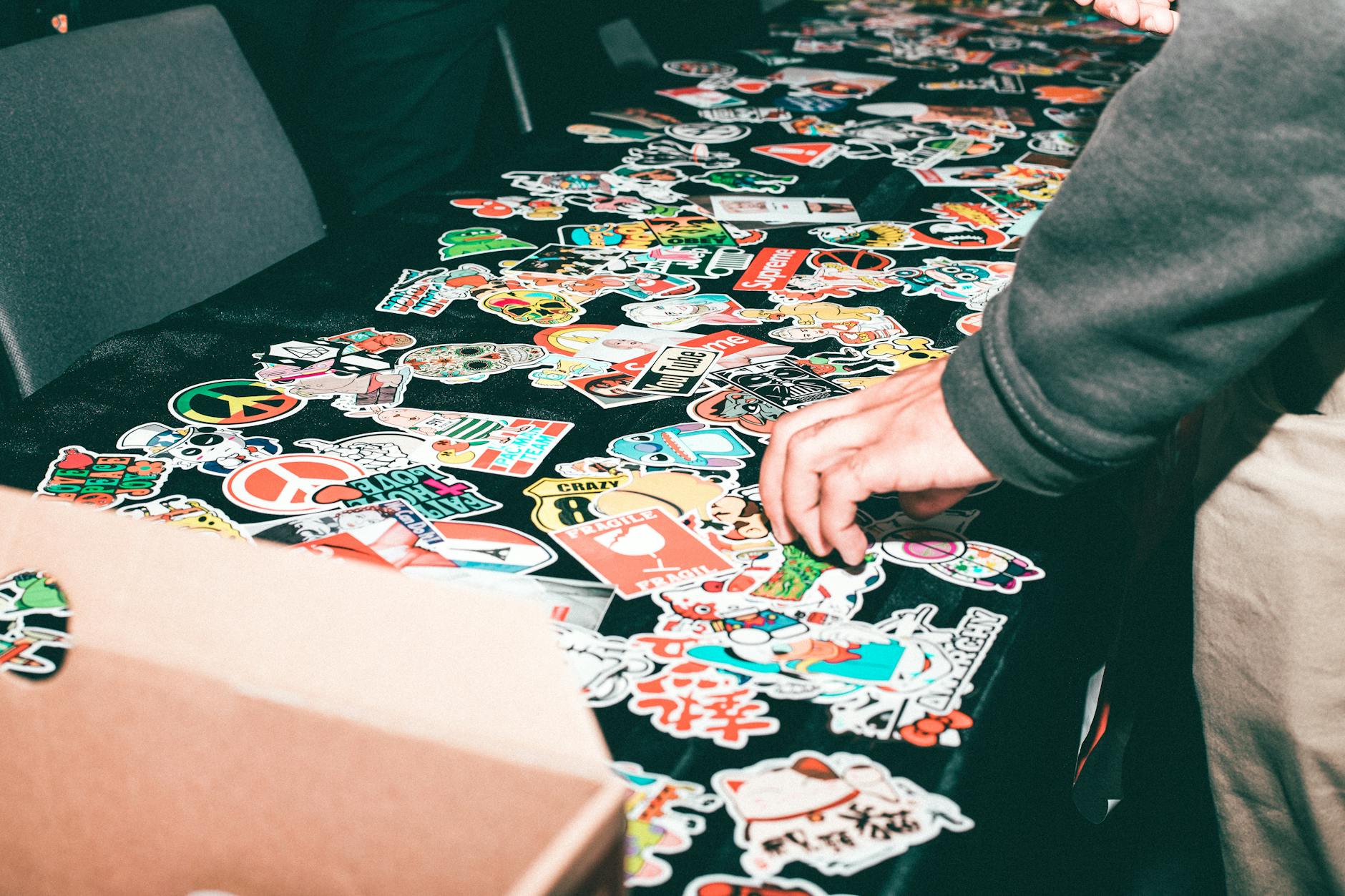 collection of custom vinyl stickers with varied finishes laid out on a white surface showing gloss and matte options