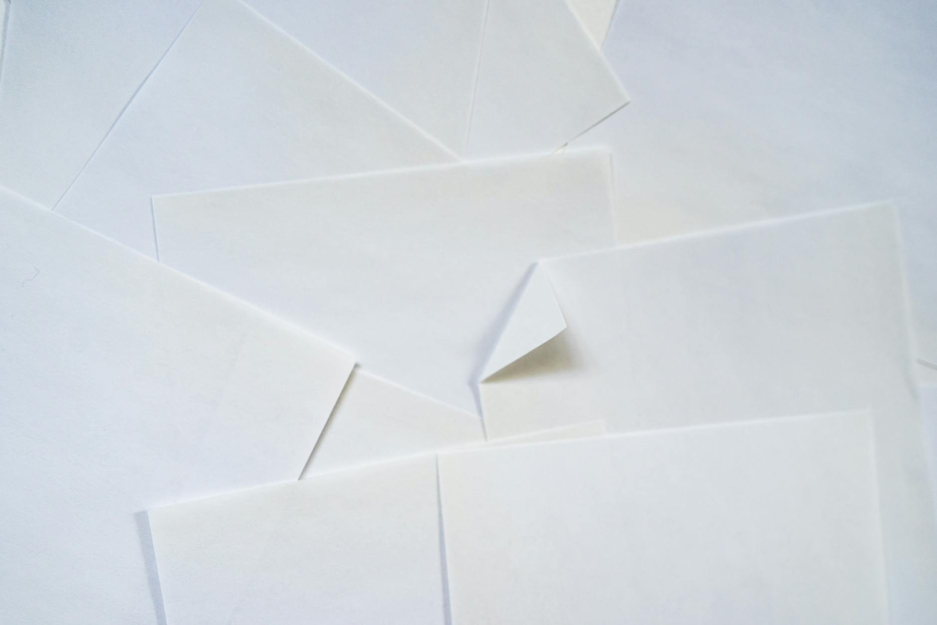 overhead flat-lay of A4 and A5 sticker sheets side by side on a white desk, showing the size difference with a ruler for scale, both sheets