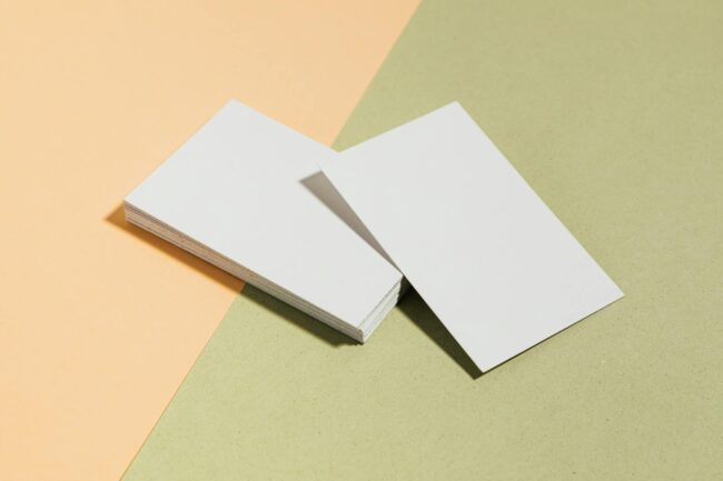 Detail shot of a Spot UV business card showing a glossy logo and brand name contrasting sharply against a matte base, photographed in angled