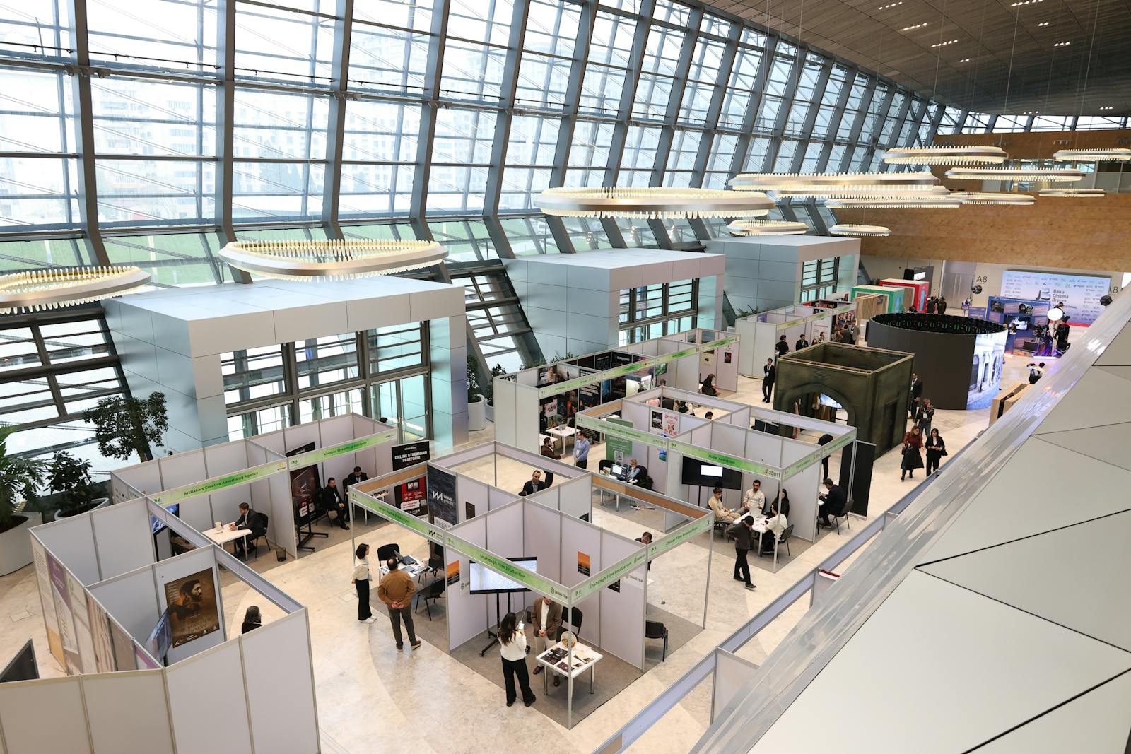 A trade show exhibition floor lined with display booths