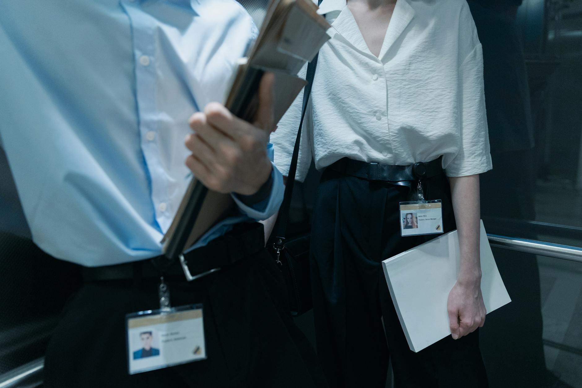 professional holding a business card case at a corporate conference, selective focus on the case with a soft-blurred event backdrop