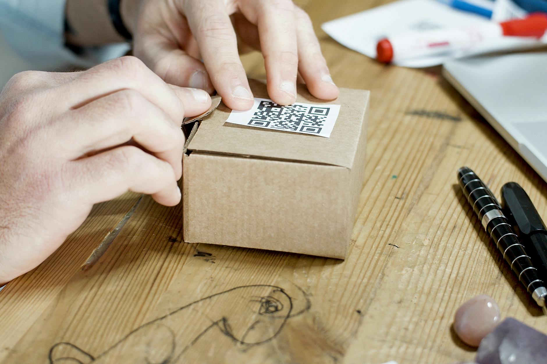 Diagram-style close-up of a QR code on a business card showing the quiet zone margin clearly marked, with annotations indicating the module