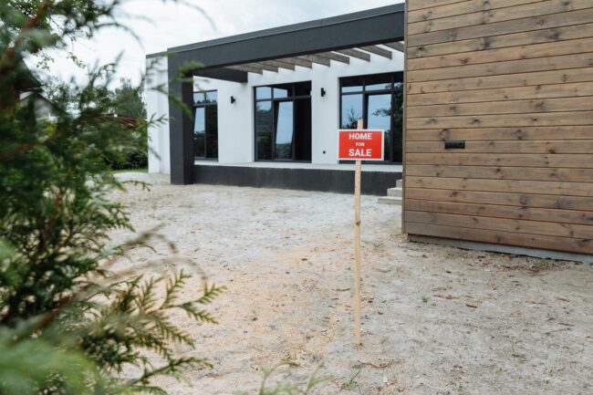 Real estate A-frame sign with bold agent branding on a suburban street, 600x900mm metal frame, professional full-colour print