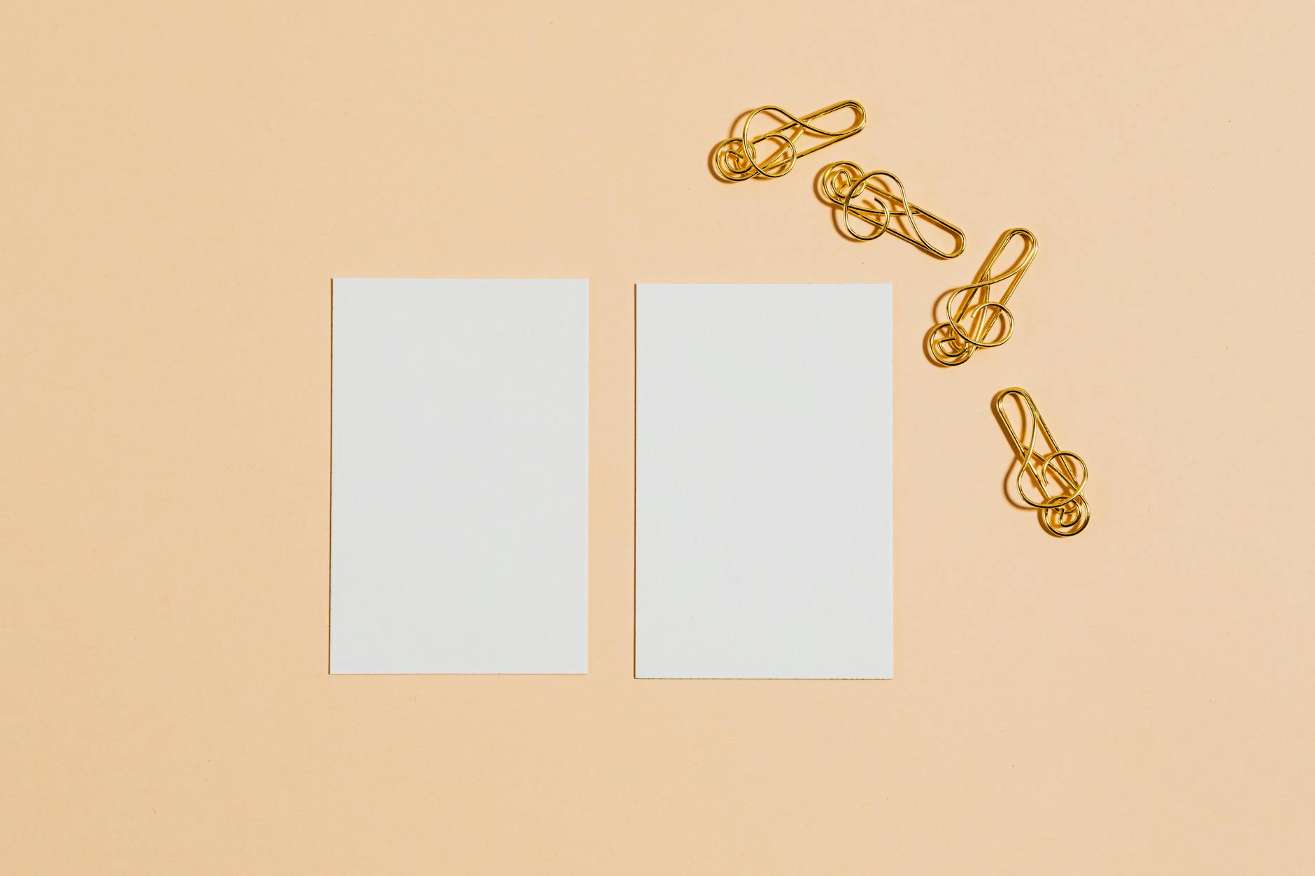Side-by-side comparison of two business cards on recycled natural white stock - one with spot UV varnish showing a gloss-matte contrast on t
