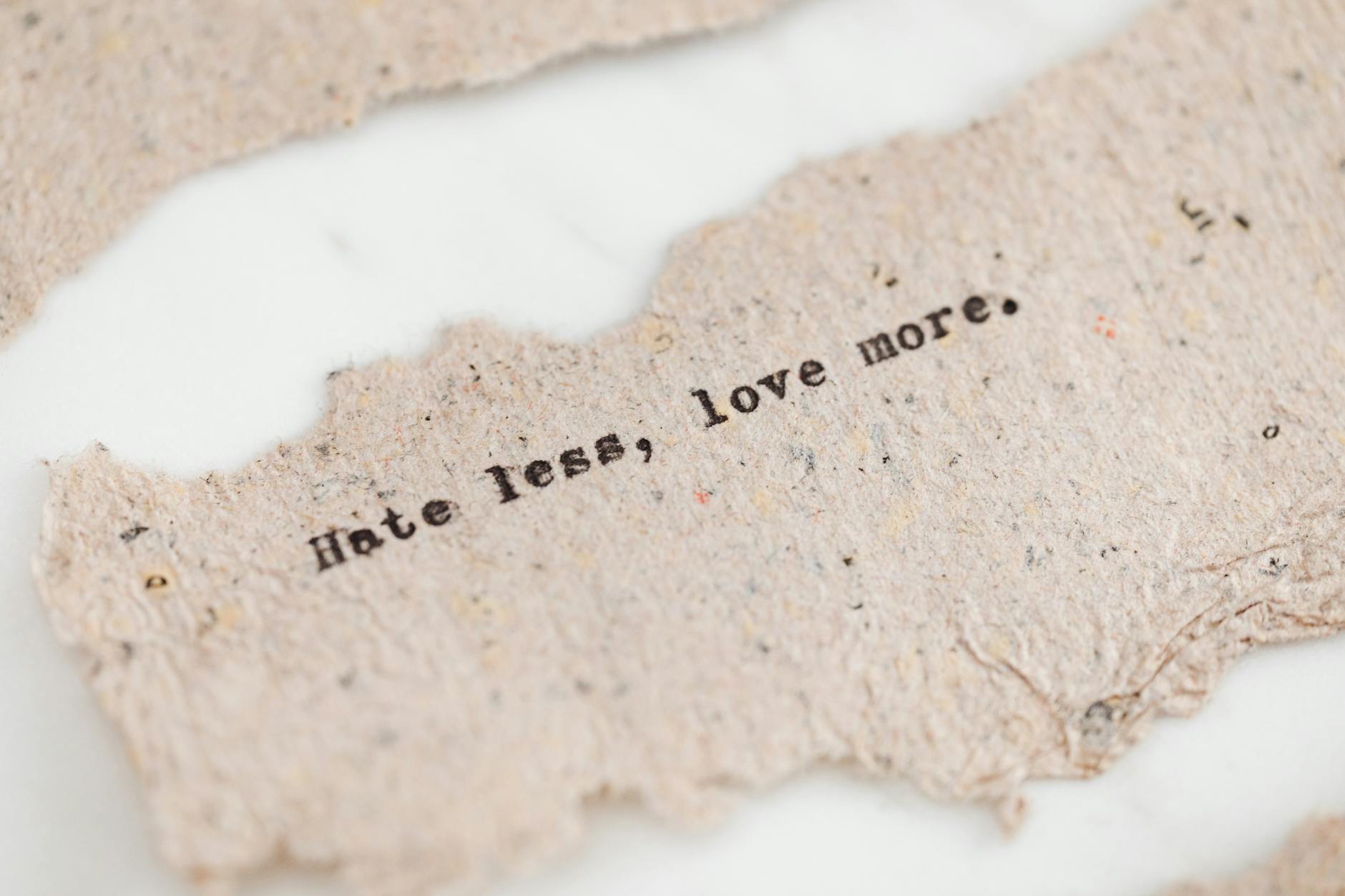 Close-up of a recycled business card front showing crisp sans-serif typography and generous white space on natural white recycled stock, ill