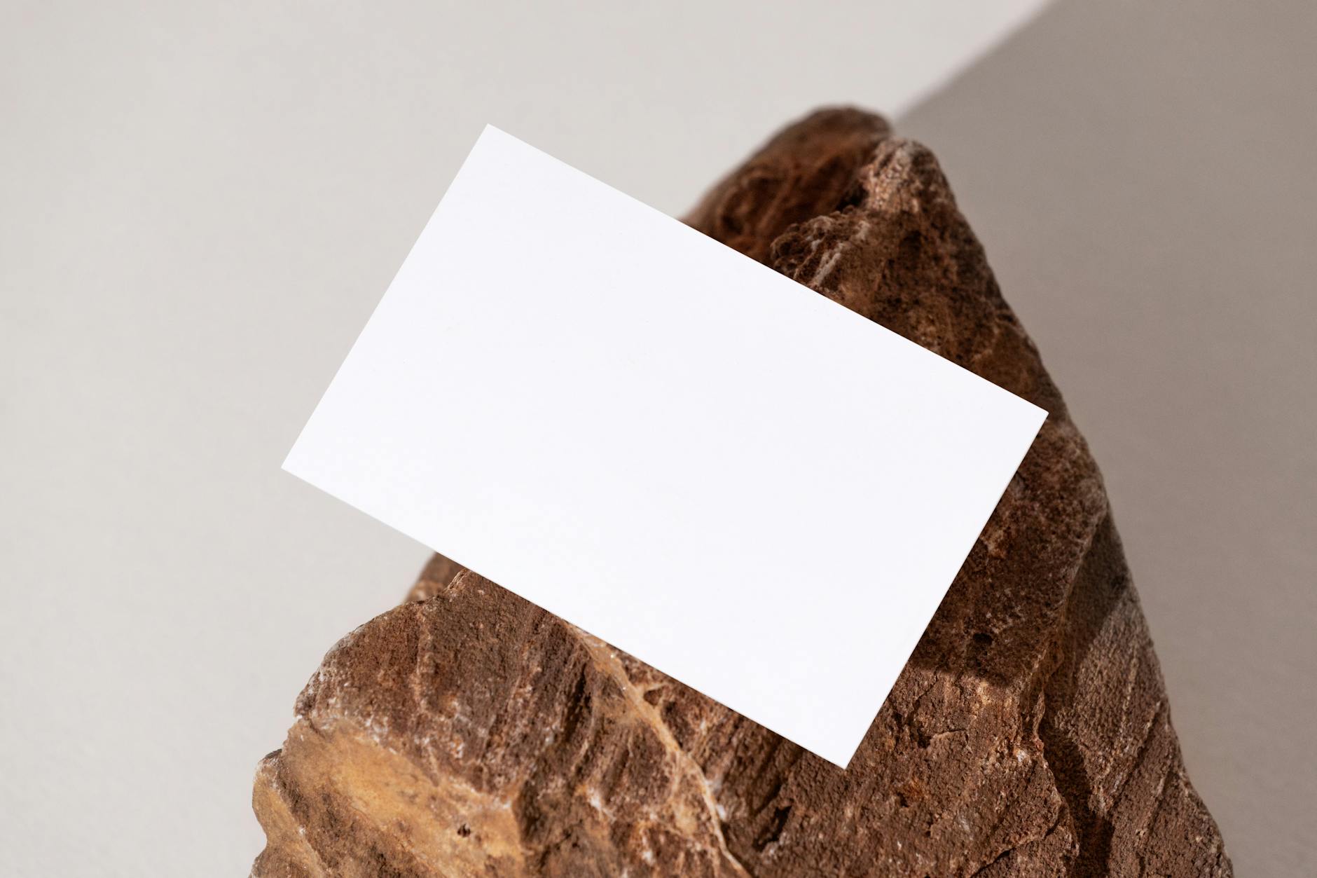 Close-up of a startup business card showing front with clean logo and minimal contact details, flipped to reveal a QR code and brand tagline