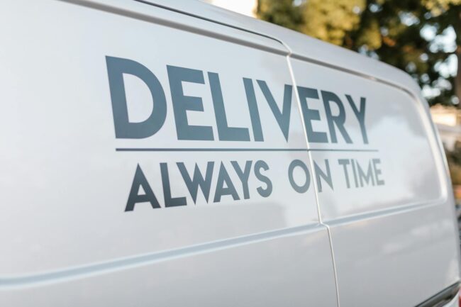 Branded vinyl sticker on a commercial van door in an Australian outdoor setting, showing vibrant colour and clean edge adhesion in bright su