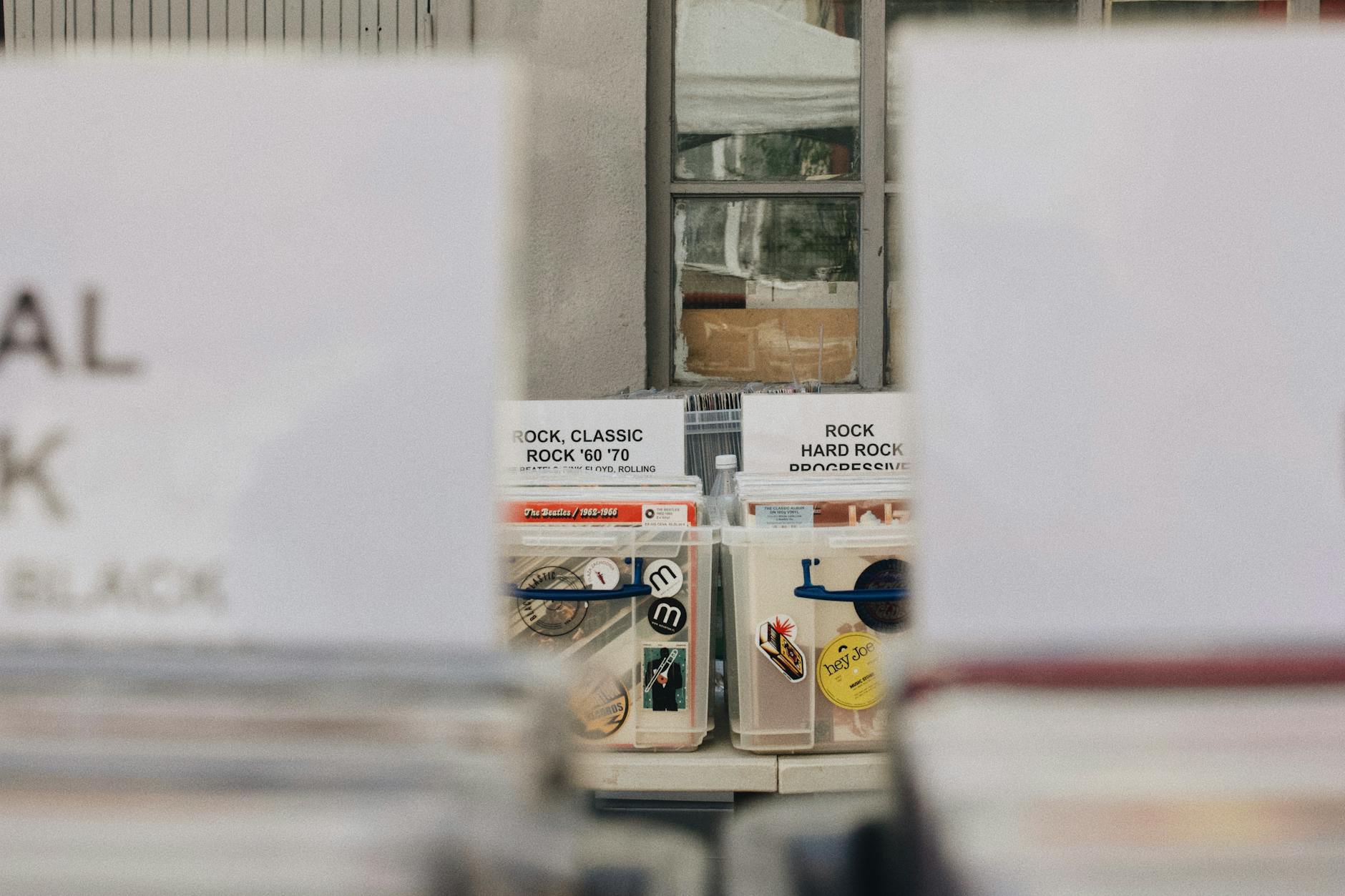 Row of cast vinyl promotional stickers on a shopfront window in a busy Australian commercial strip, showing vibrant colour and clean adhesio