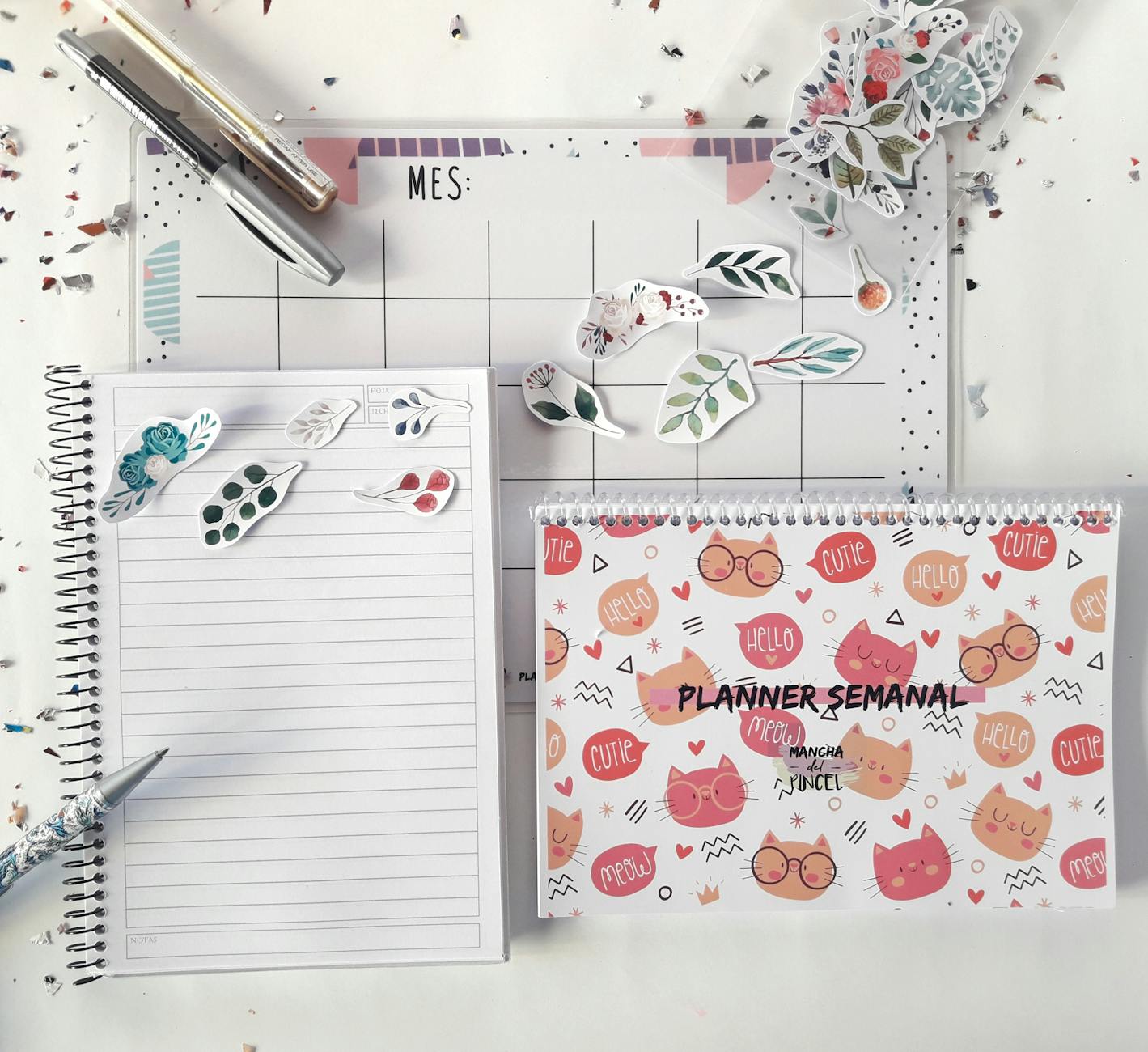Flat lay of three different launch sticker designs spread on a clean white surface - a round logo sticker, a hashtag script sticker, and a c