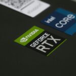 Close-up of high-quality Australian-printed custom die-cut stickers in white and gold, showing precise edge cuts and vibrant colour on a fla