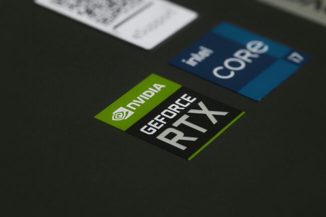 Close-up of high-quality Australian-printed custom die-cut stickers in white and gold, showing precise edge cuts and vibrant colour on a fla