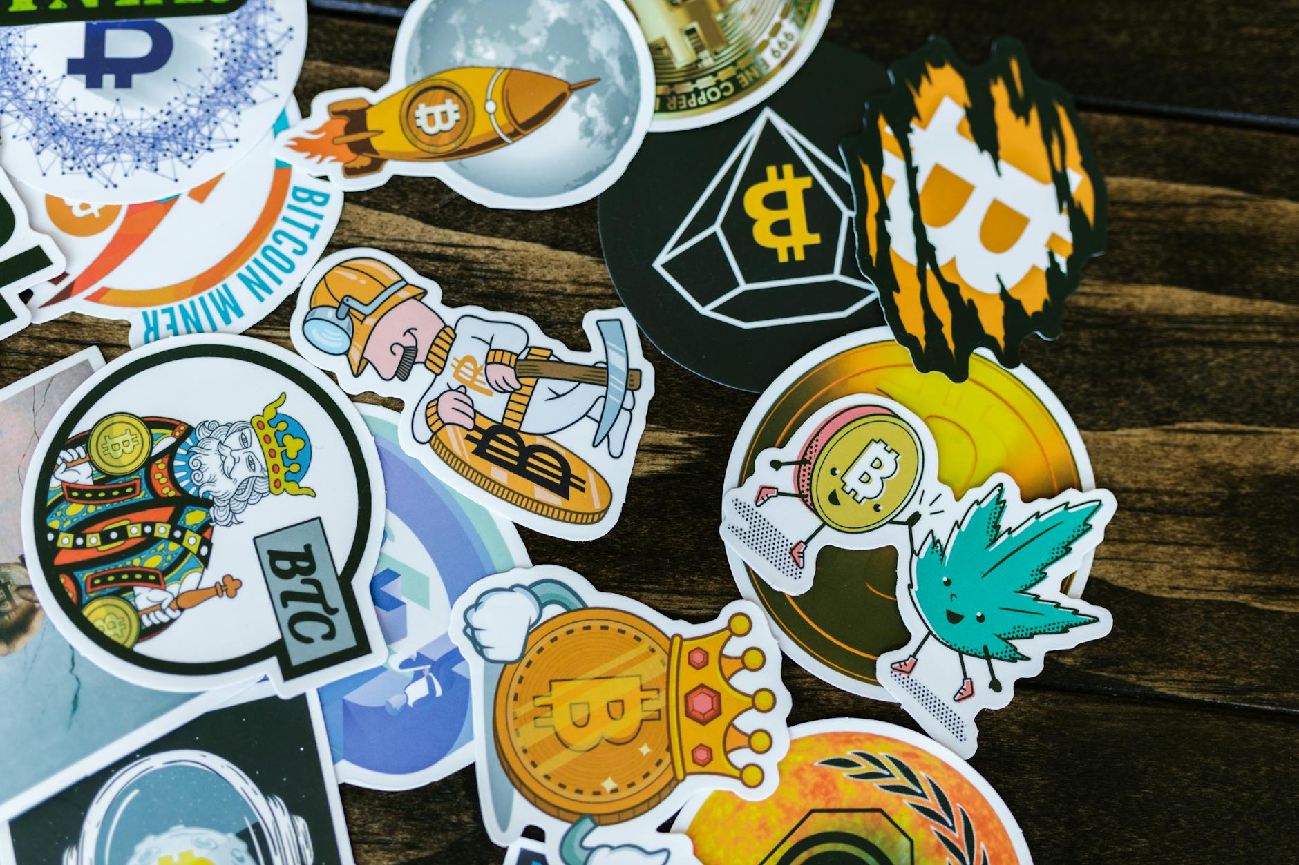 A spread of four individually backed die-cut stickers in different shapes fanned out on a pastel blue background, showing contour-cut edges