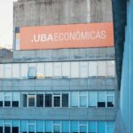 Wide-format vinyl banner mounted on a commercial building facade, vivid full-colour print, outdoor setting, storefront or construction hoard