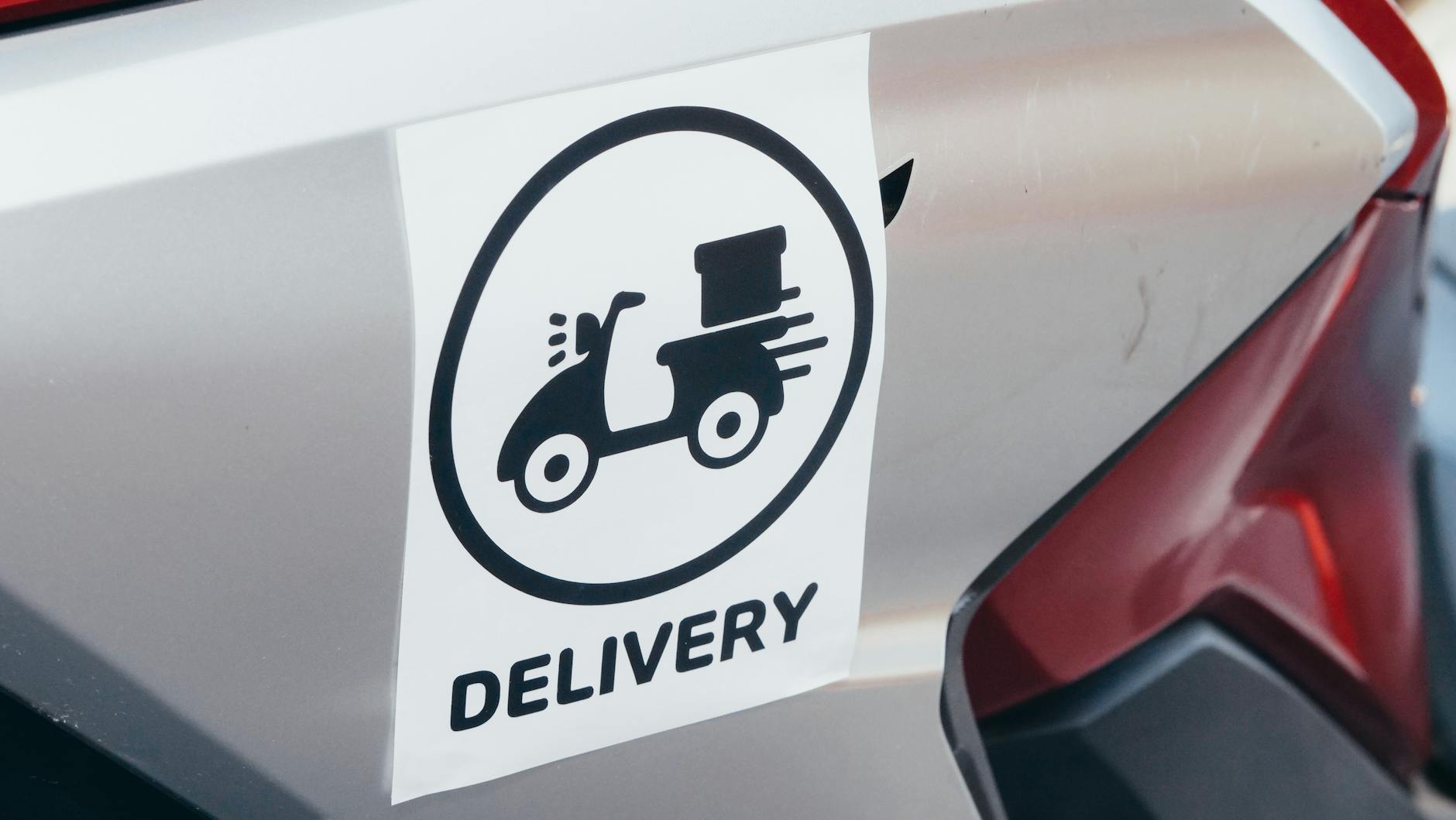 custom die-cut logo stickers applied to a fleet of trade utes in an outdoor yard, showing consistent branding across multiple vehicles