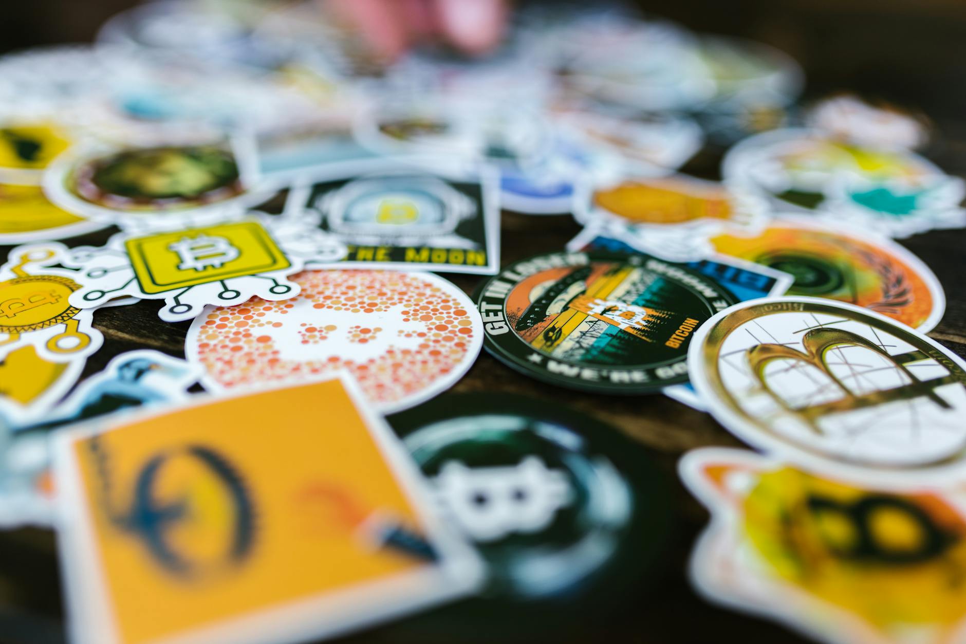 close-up of die-cut custom vinyl stickers with glossy printed designs and kiss-cut white borders
