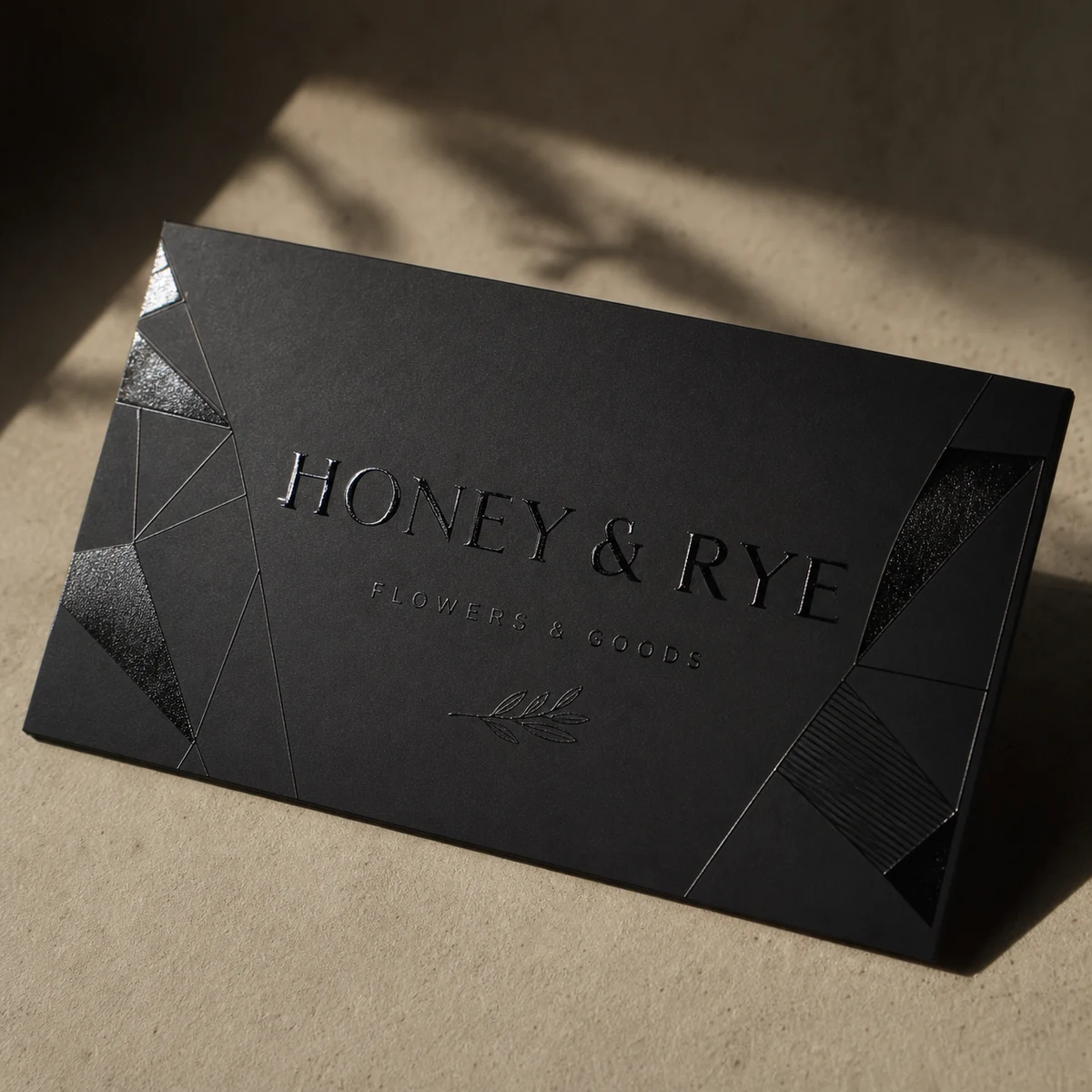 Black business card · matte black coloured stock · full-colour digital print · spot UV, tonal black-on-black