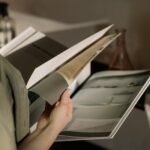 A stack of professionally printed saddle-stitched booklets with laminated covers.