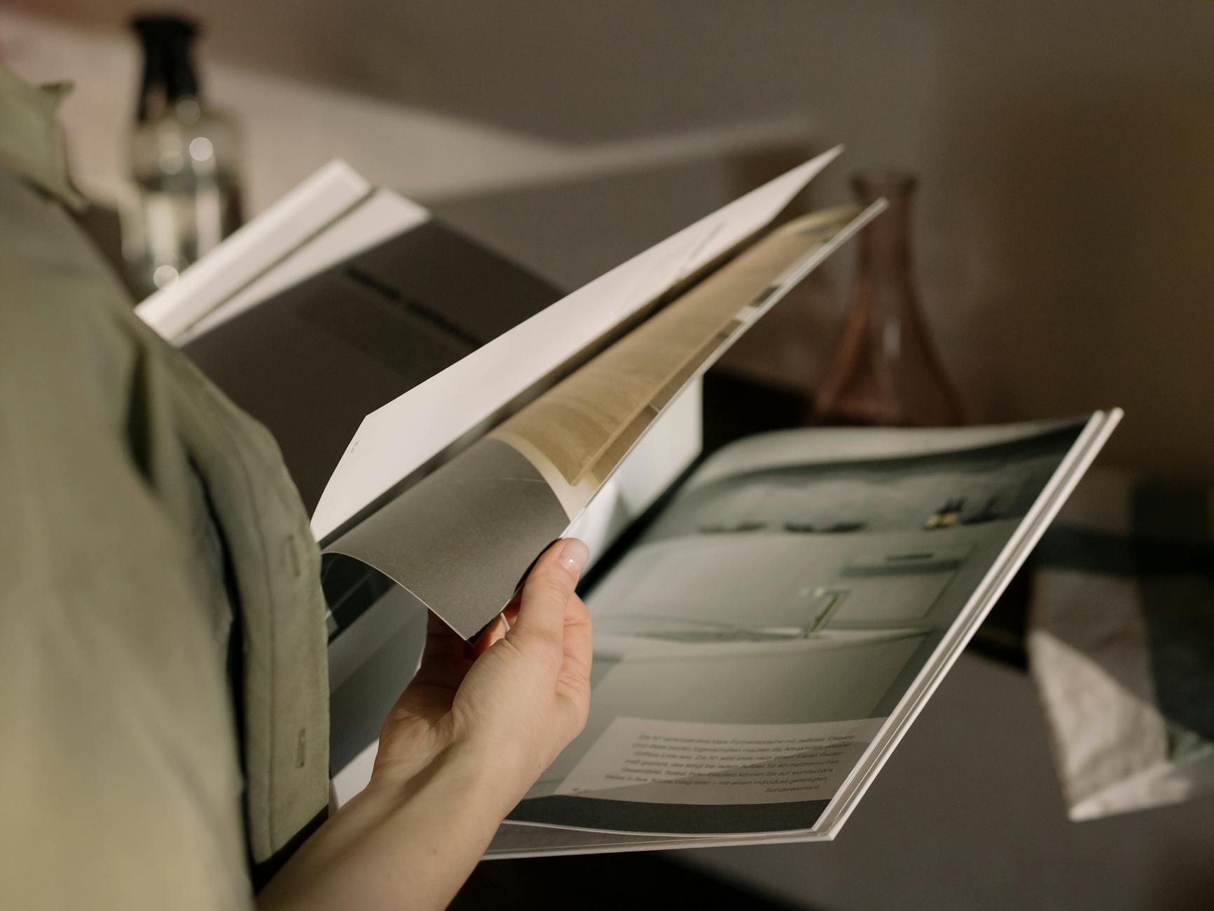 A stack of professionally printed saddle-stitched booklets with laminated covers.
