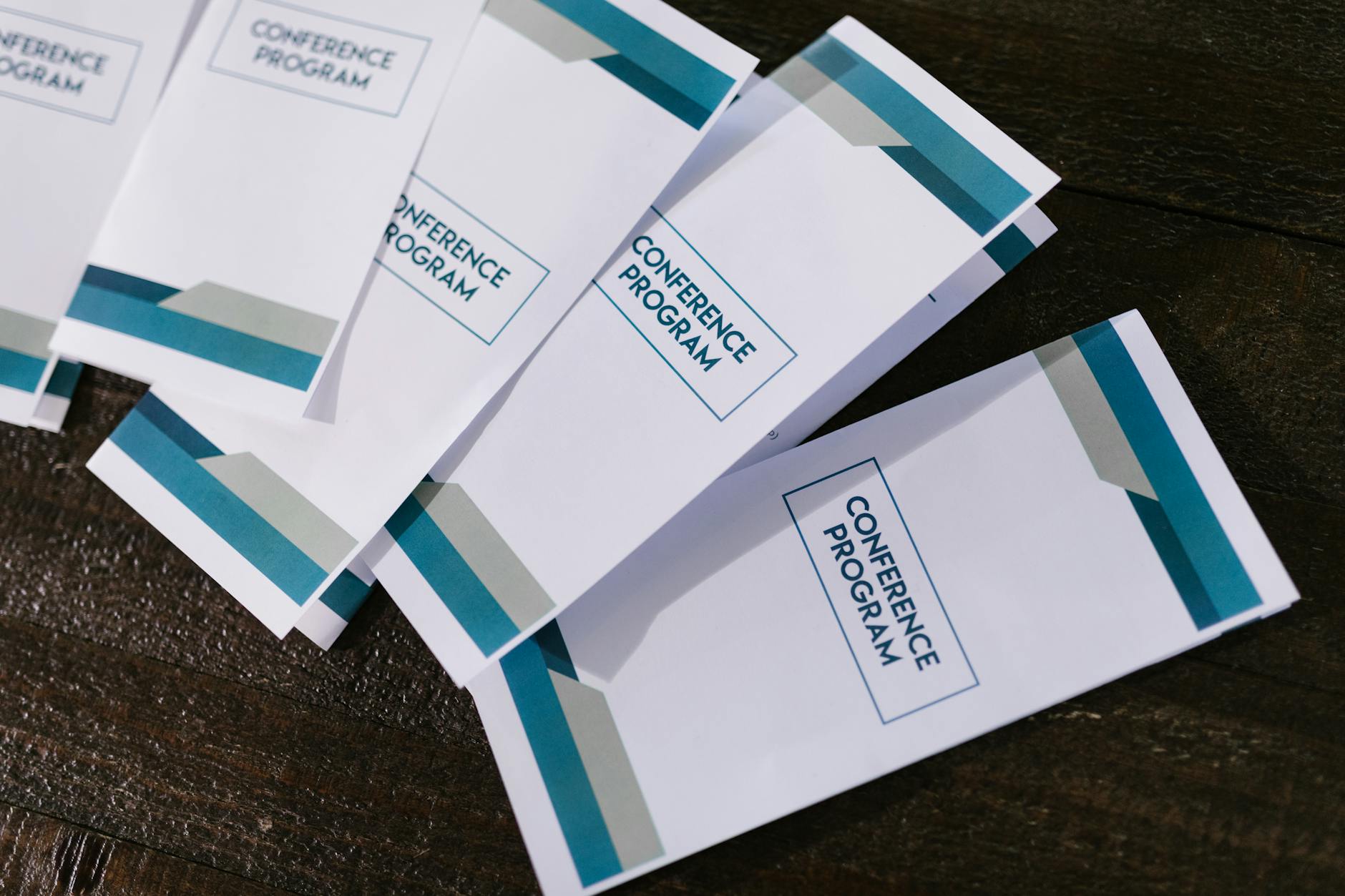 An A4 bi-fold brochure printed for a hospitality or real estate brand, open and face-up on a table, showing full-colour panels
