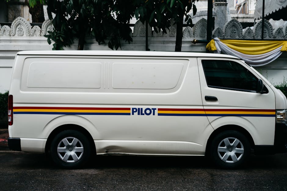 White work van with printed company branding on the side panel
