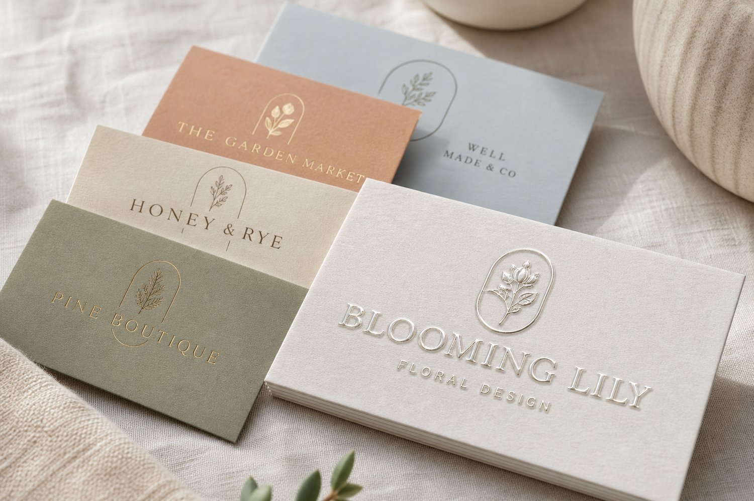 Premium business cards with a raised dimensional clear-gloss Scodix finish on the wordmark, sitting proud of a matte card.