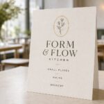 A boutique restaurant menu propped on a table, illustrating restaurant menu printing paper and lamination options.