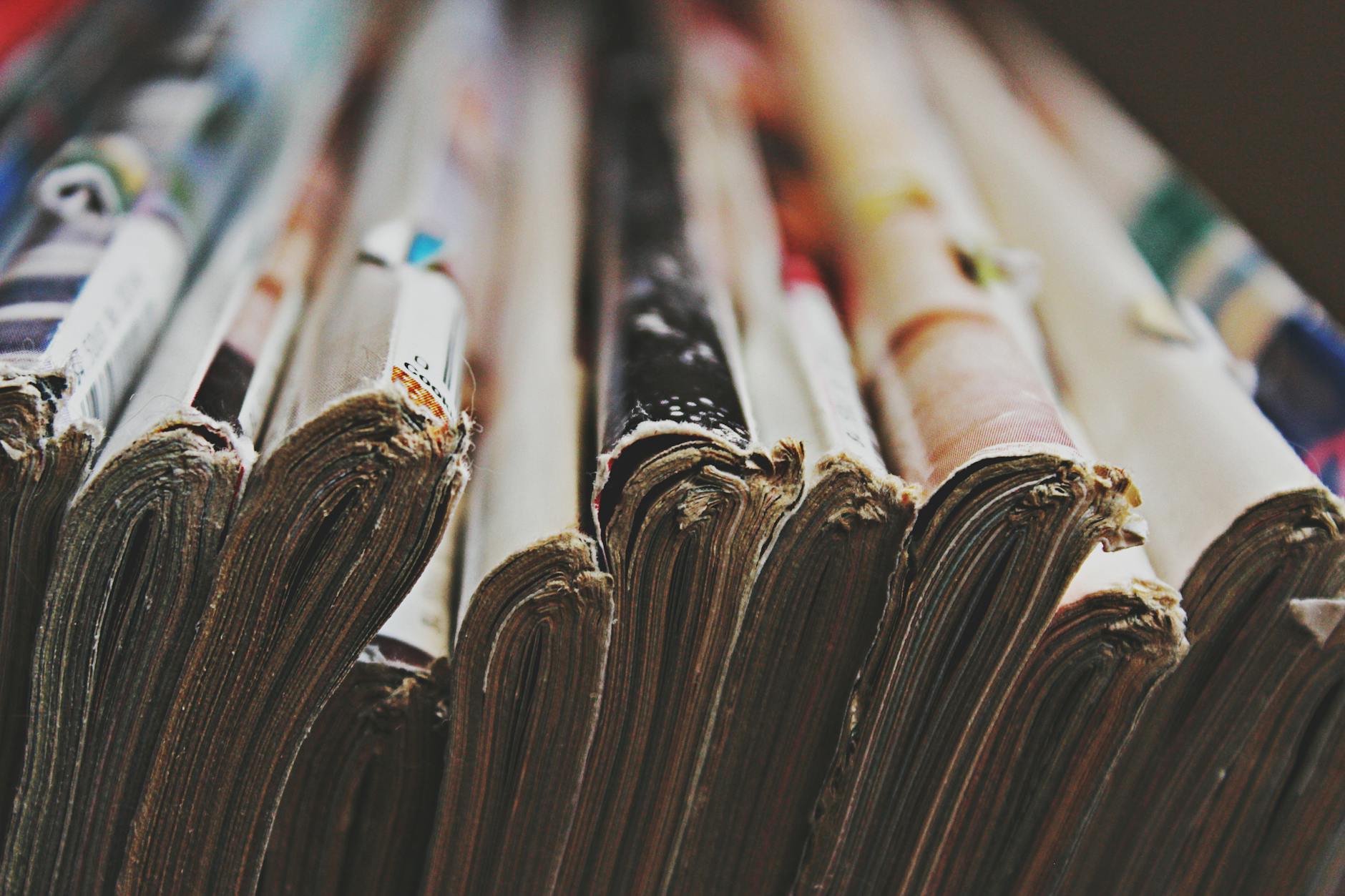 Close-up of an open A4 catalogue showing a product spread with full-colour photography on gloss coated internal pages, with a laminated