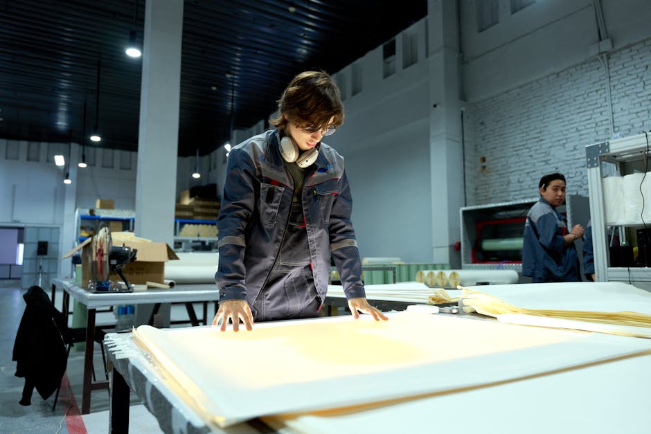 A print worker checking freshly printed sticker sheets in the factory