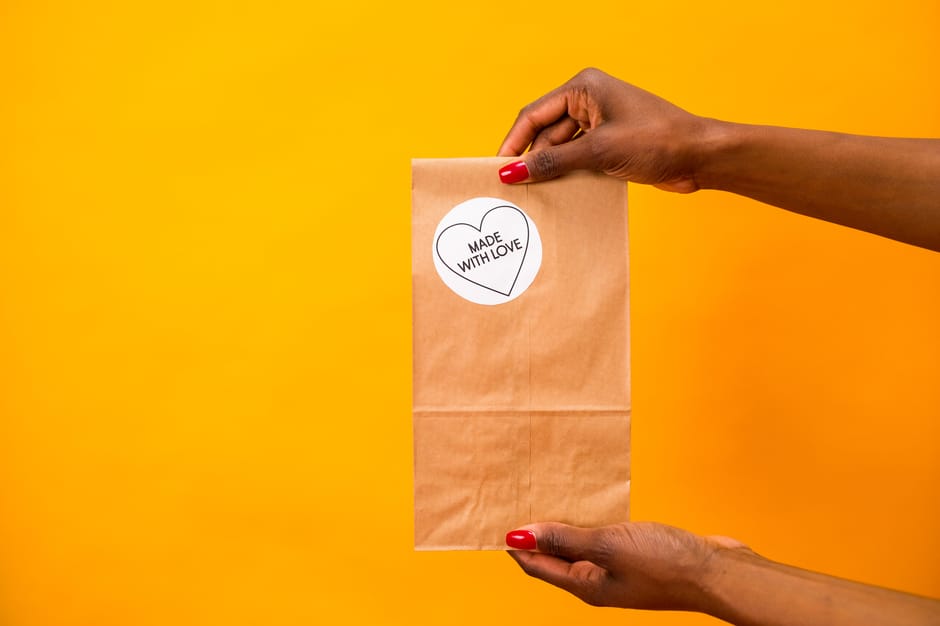 A kraft paper bag finished with a printed Made with Love sticker