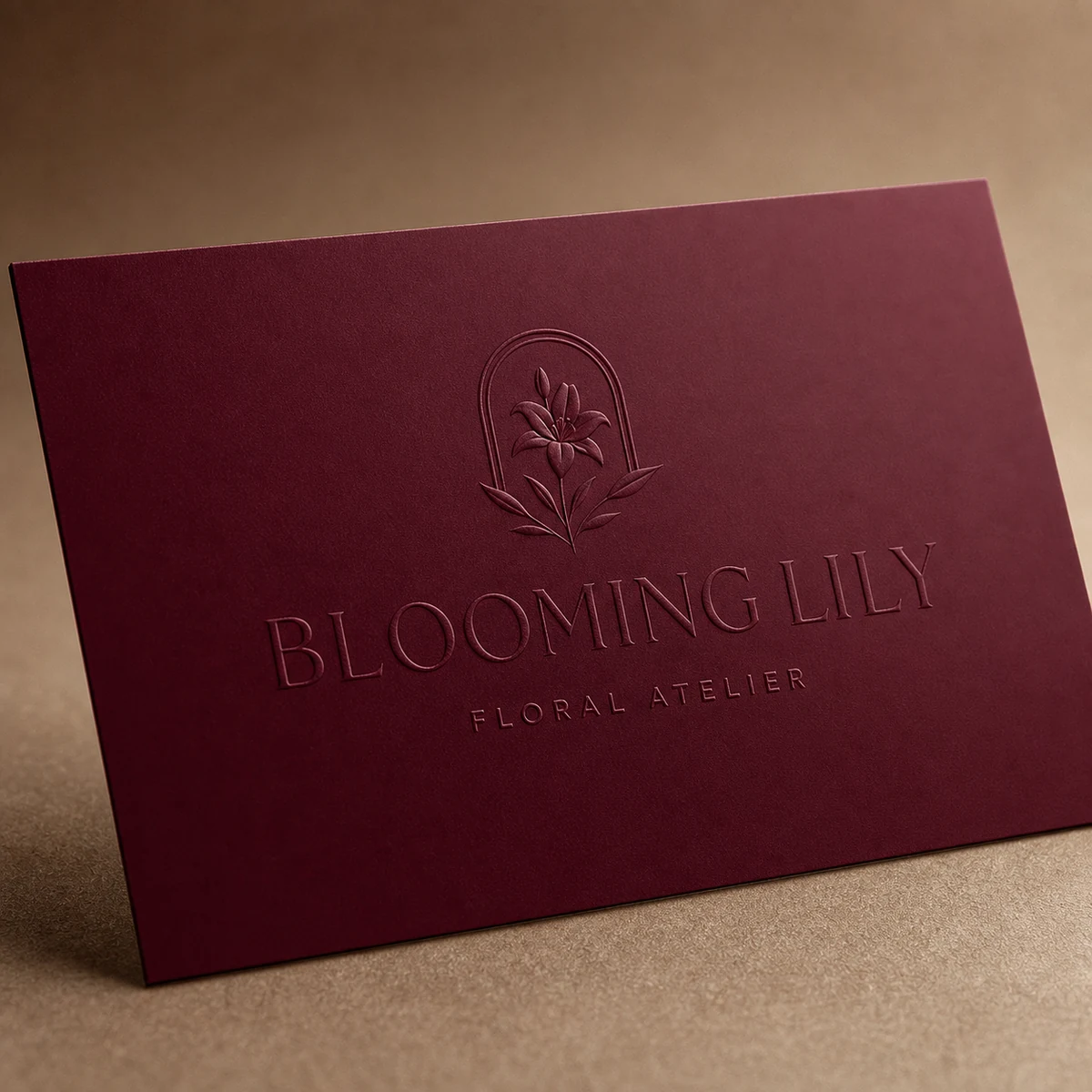 Business card, burgundy · 400gsm uncoated stock · offset print · blind deboss, tone-on-tone recessed