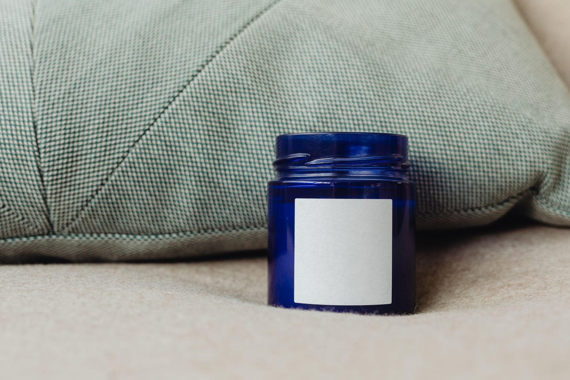Clear vinyl label applied to a glass honey jar, showing the no-label look effect with printed text and a botanical design visible against