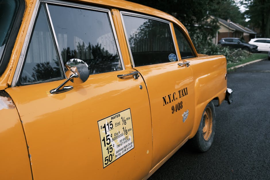 Printed signage lettering on the door of a vehicle on a city street