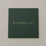Forest-green business card, dead-flat matte · 350gsm matte-coated stock · full-colour digital print · matte laminate