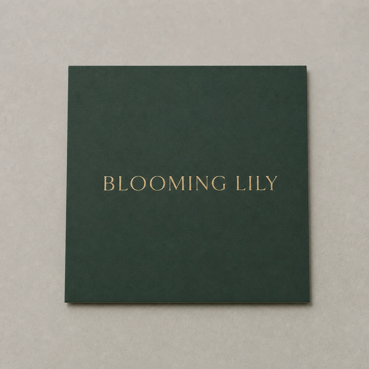 Forest-green business card, dead-flat matte · 350gsm matte-coated stock · full-colour digital print · matte laminate