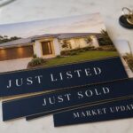 Fanned stack of rectangular real-estate marketing postcards with property-led designs on a neutral surface, used for letterbox campaigns.