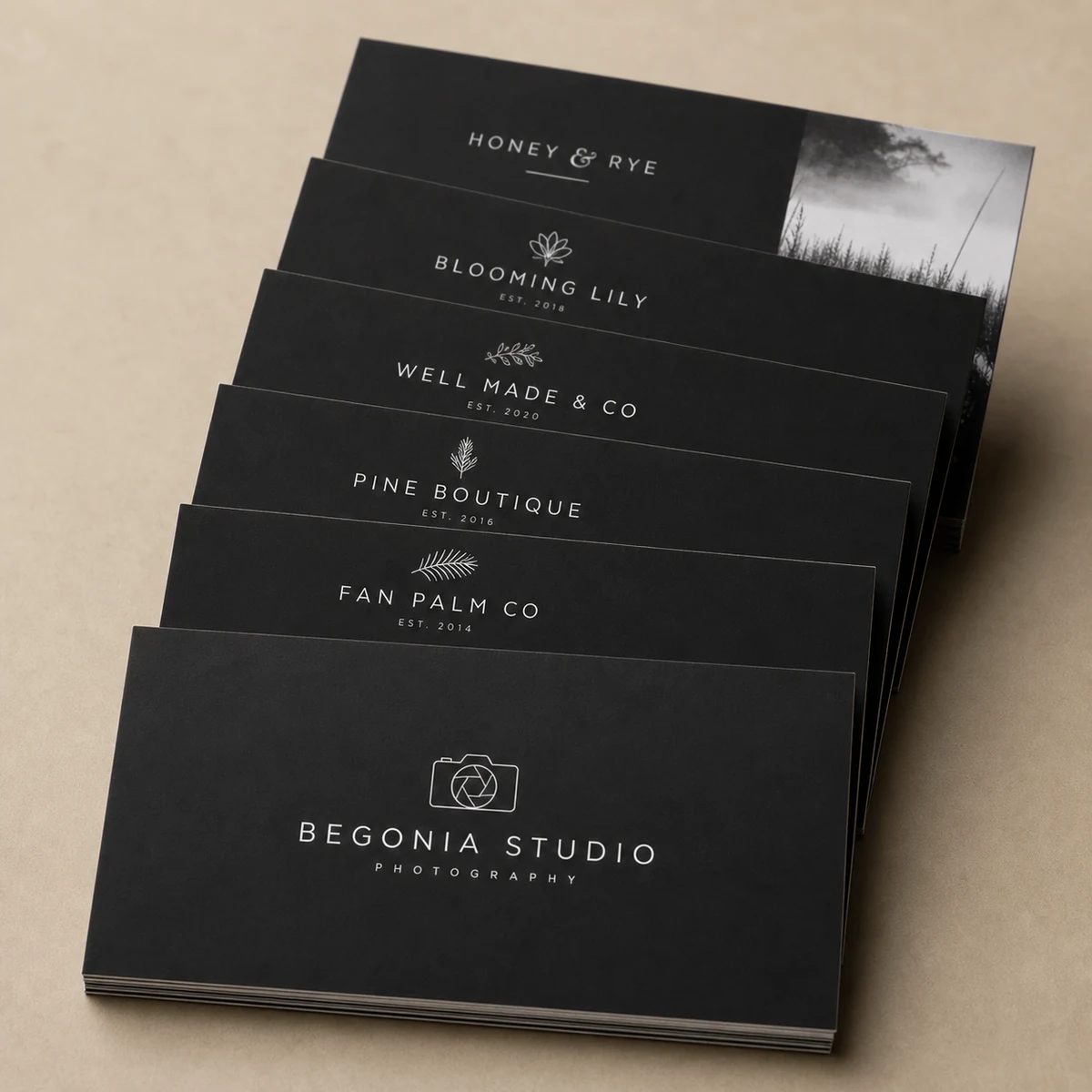 Photographer business cards, charcoal · 350gsm soft-touch stock · full-colour digital print · soft-touch matte laminate
