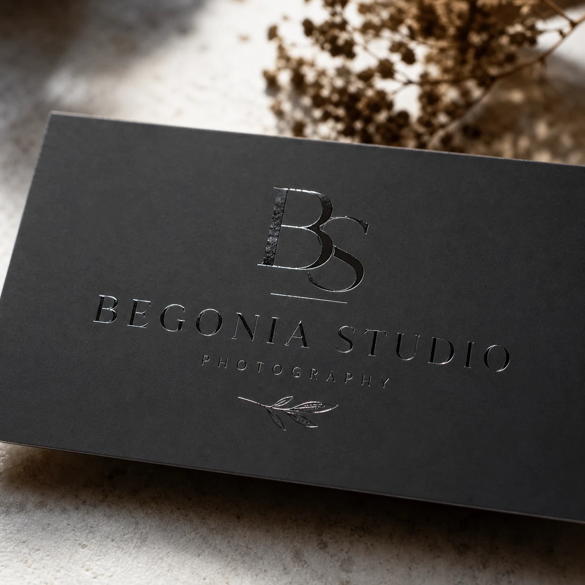 Photographer business card, charcoal · 350gsm matte stock · full-colour digital print · spot UV gloss monogram