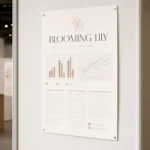 A1 portrait research poster pinned on a clean white exhibition board at a conference, a bold legible title band above muted abstract chart blocks and columns of fine body text
